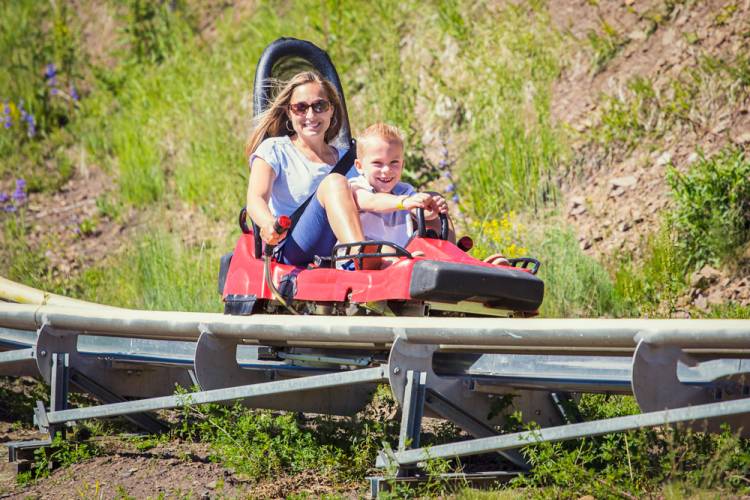 Mother and daughter on an alpine slide 