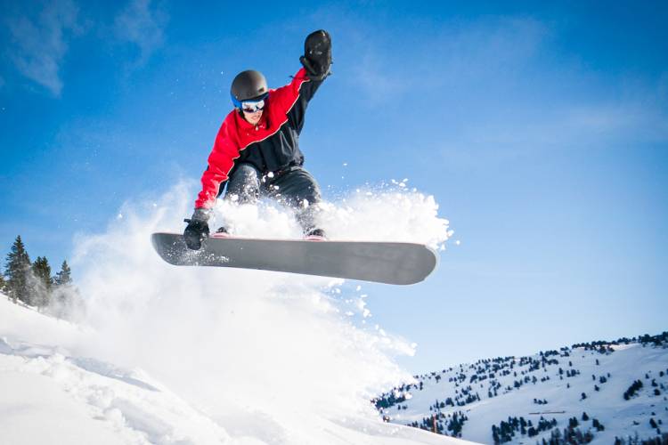 Person making a jump while snowboarding